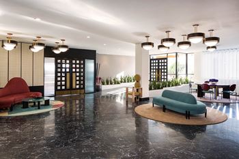 The lobby or reception area of a hotel with couches and chairs